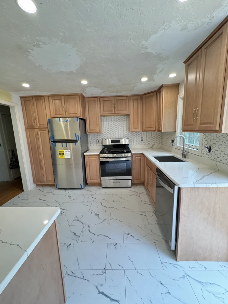 Kitchen with custom lighting and tile backsplash