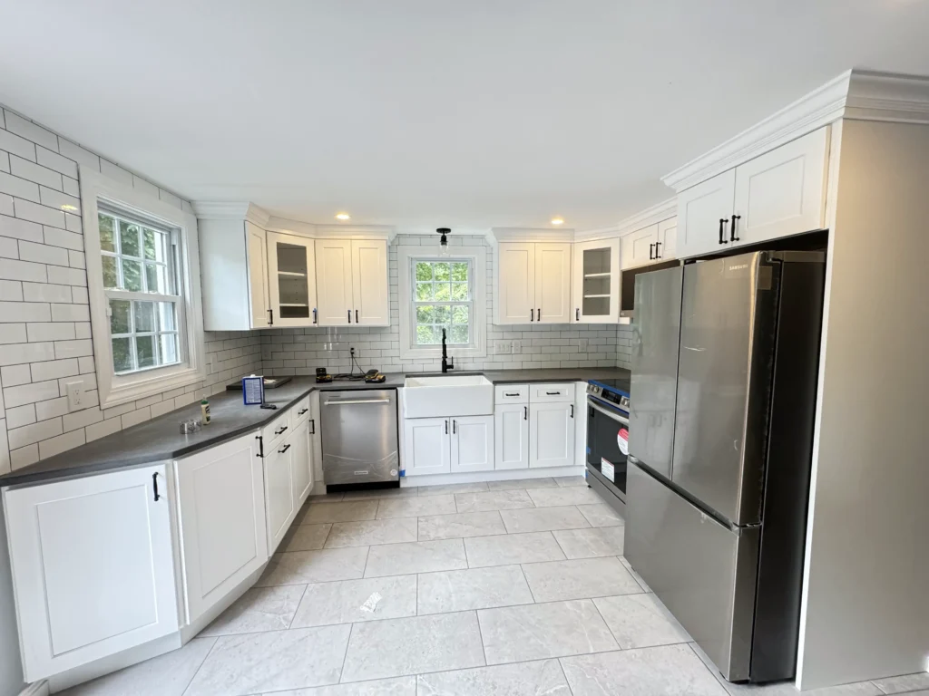 White kitchen with large island and pendant lighting