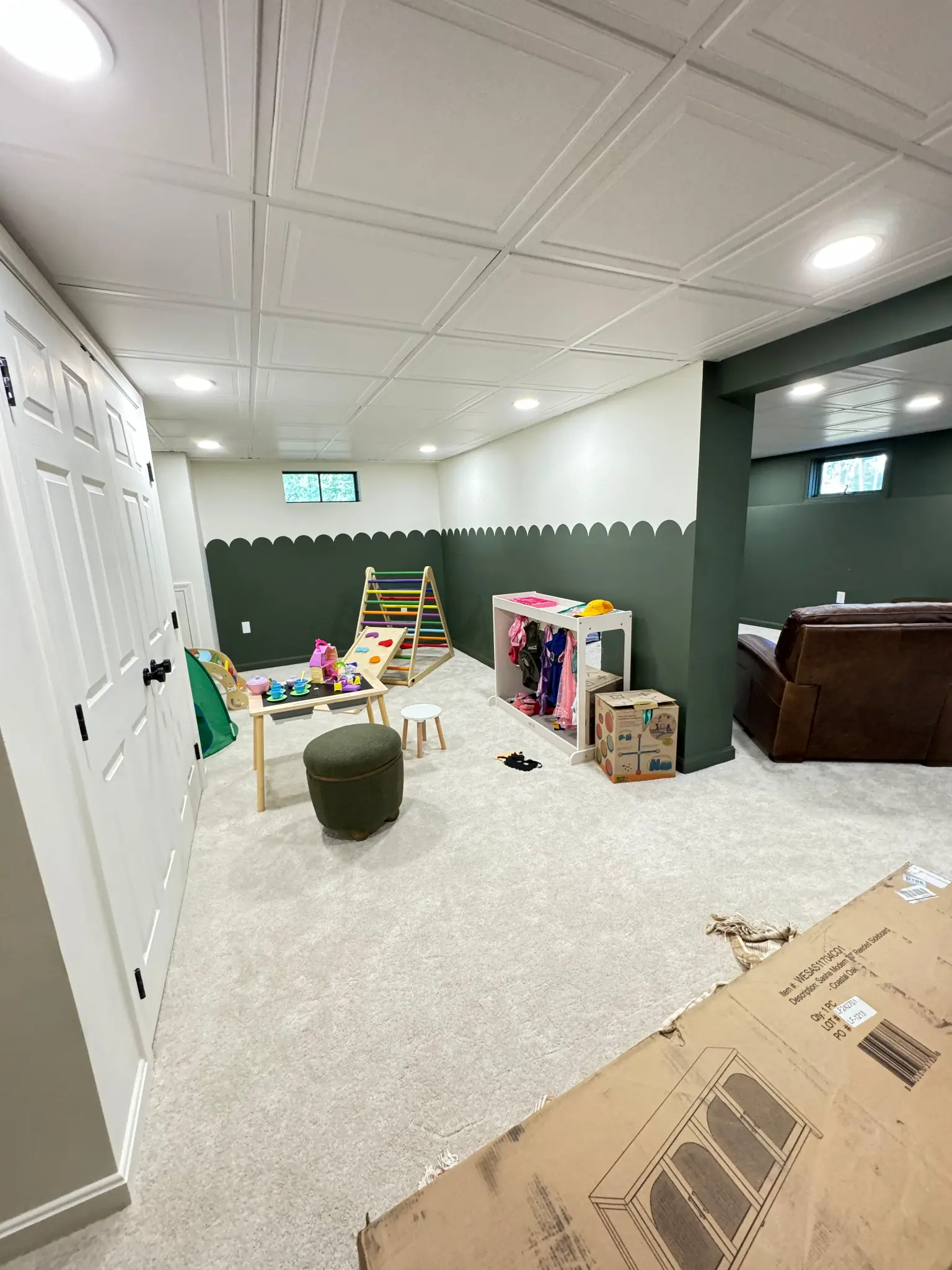 Finished basement kids playroom with climbing toys and storage by Regulus Construction