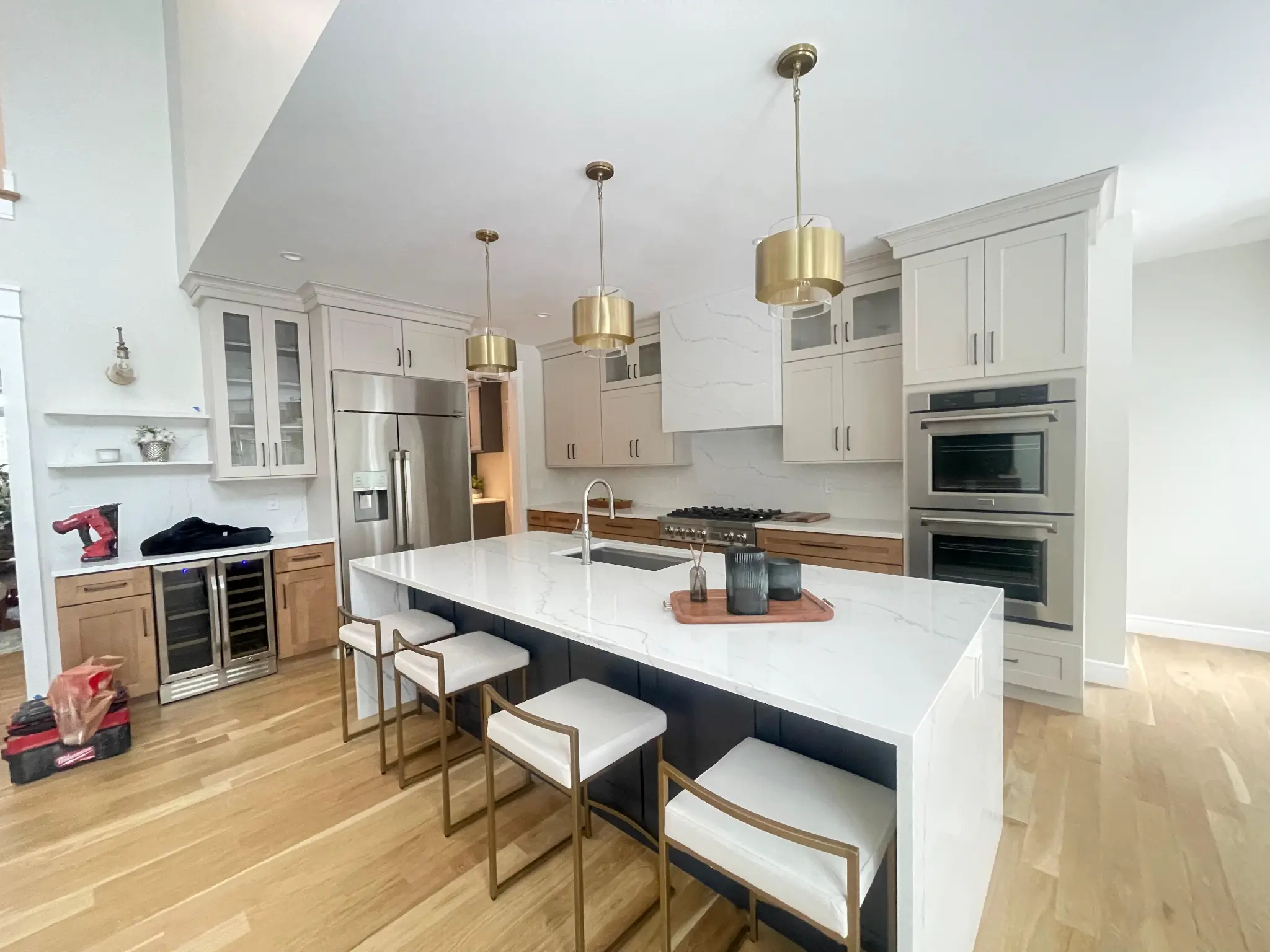 Luxury kitchen with quartz waterfall island and wine fridge in MA